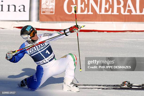 Italian's Massimiliano Blardone pretends to hold a bow and arrow after finishing third of the second run of the FIS World Cup Alpine Men's Giant...