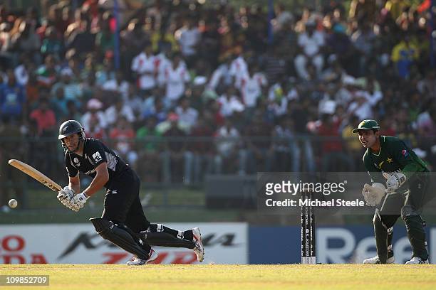 Ross Taylor of New Zealand plays to the legside as wicketkeeper Kamran Akmal looks on during the New Zealand v Pakistan 2011 ICC World Cup Group A...