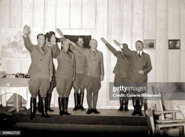 Adolf Hitler and visitors to the Berghof giving the Nazi salute, Berchtesgaden, Germany, 1942. Among the guests are Foreign Minister Joachim von...