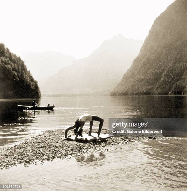 Eva Braun exercising in her bathing suit at Konigssee, Berchtesgaden, Germany, 1942. Eva Braun liked to go swimming at the lake, which is only 4...