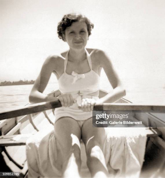 Eva Braun rowing a boat on the Worthsee near Munich, 1937. She had started a relationship with Adolf Hitler in 1931 and moved into the Berghof, his...