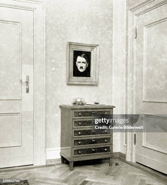 Portrait of Adolf Hitler in Eva Braun's living room at the Berghof near Berchtesgaden, Germany, 1937. Braun's rooms connected with Hitler's. She...