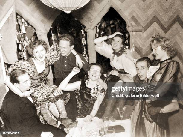 Photograph from the personal album of Eva Braun showing carnival celebrations at her parents house in Munich, Germany, 1938. Among the group are her...