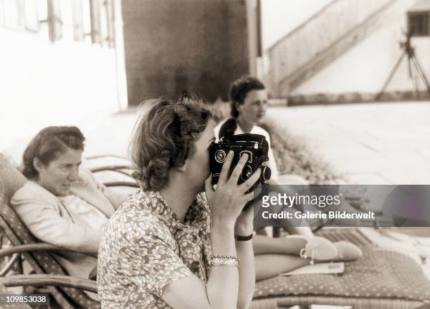 Eva Braun filming with her 16mm camera at Berchtesgaden, Germany, 1942. Occasionally she used color film and many years later these films became...
