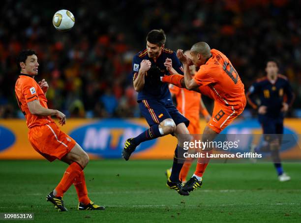 Nigel De Jong of the Netherlands tackles Xabi Alonso of Spain during the 2010 FIFA World Cup South Africa Final match between Netherlands and Spain...