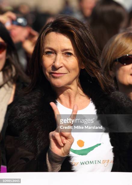 Cherie Lunghi joins together to lead a march in aid of International Women's Day at Millennium Bridge on March 8, 2011 in London, England.