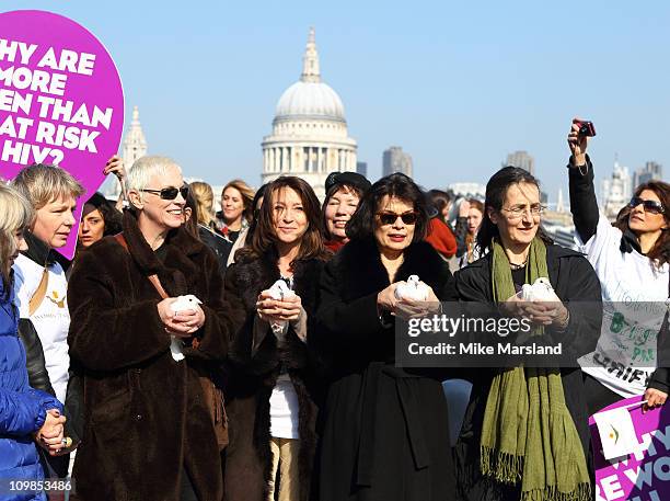 Annie Lennox , Cherie Lunghi and Bianca Jagger join together to lead a march in aid of International Women's Day at Millennium Bridge on March 8,...