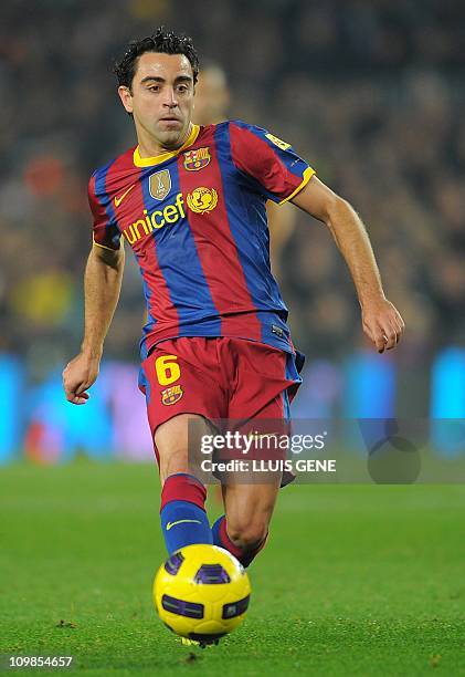 Barcelona's midfielder Xavi Hernandez kicks a ball during their Spanish League football match FC Barcelona vs Real Sociedad on December 12, 2010 at...