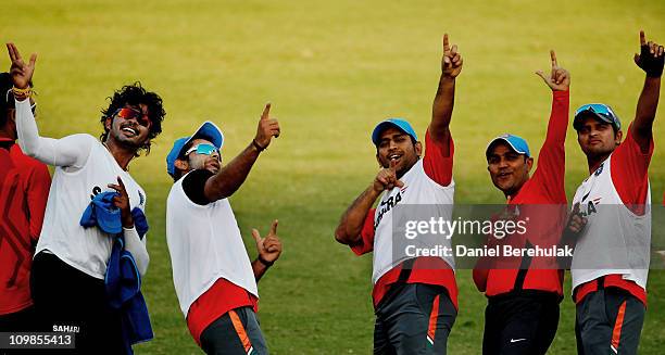 Indian players Shantakumaran Sreesanth, Virat Kohli, captain MS Dhoni, Virender Sehwag and Suresh Raina celebrate after winning a friendly warm up...