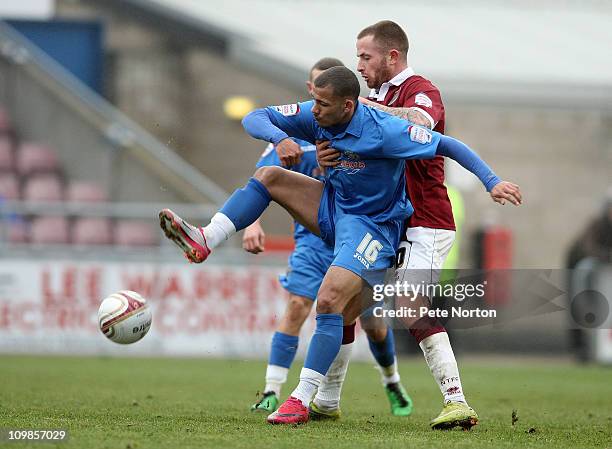 Lional Ainsworth of Shrewsbury Town attempts to control the ball under pressure from Josh Walker of Northampton Town during the npower League Two...