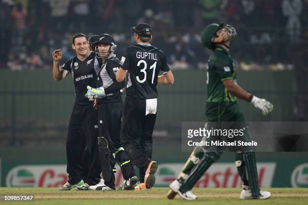 Nathan McCullum of New Zealand celebrates taking the wicket of Umar Akmal with Brendon McCullum and Martin Guptill during the New Zealand v Pakistan...