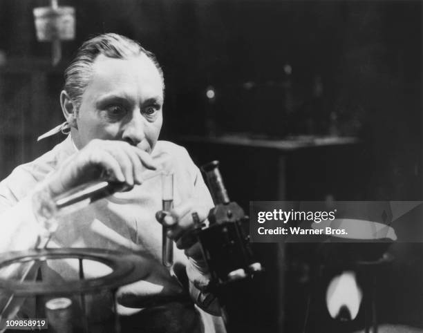 Dr Otto von Niemann, played by English actor Lionel Atwill , conducts an experiment, in a scene from 'The Vampire Bat', directed by Frank R. Strayer,...