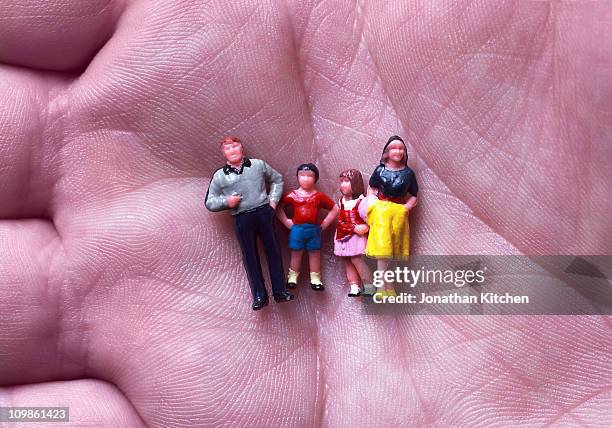 family in hand - figurine people stock pictures, royalty-free photos & images