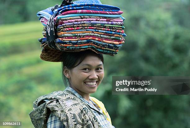 woman selling batik sarongs in rice terraces - batik indonesia stock pictures, royalty-free photos & images