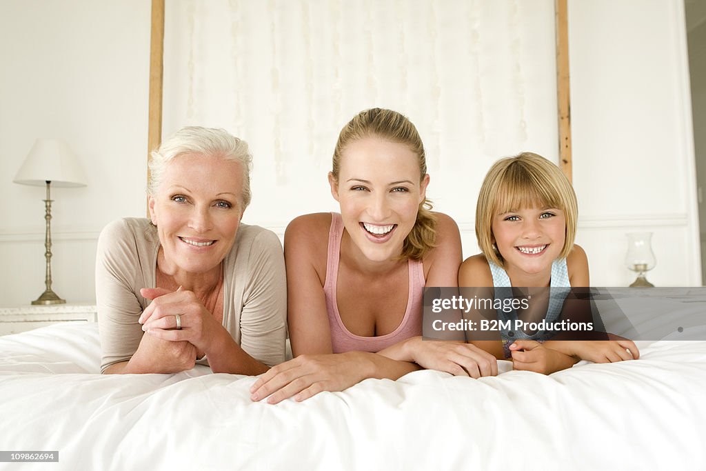 Three generations of women on bed, Portrait