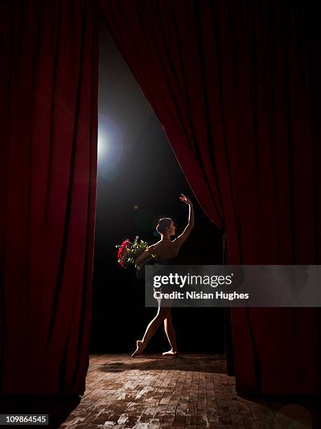 ballerina at end of show with flowers - behind the curtain stock pictures, royalty-free photos & images