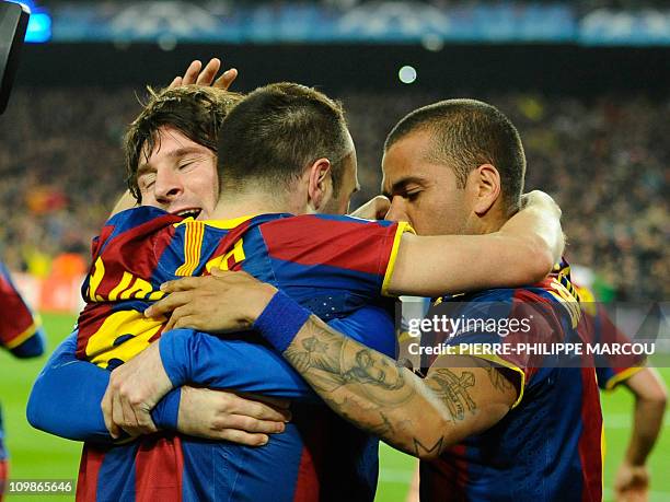 Barcelona's Argentinian forward Lionel Messi celebrates his goal with Barcelona's midfielder Andres Iniesta and Barcelona's Brazilian defender Dani...