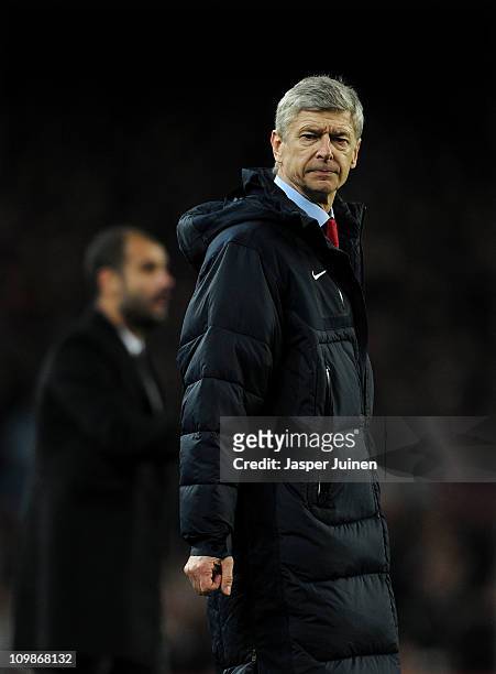 Head coach Arsene Wenger of Arsenal reacts backdropped by head coach Josep Guardiola of Barcelona during the UEFA Champions League round of 16 second...