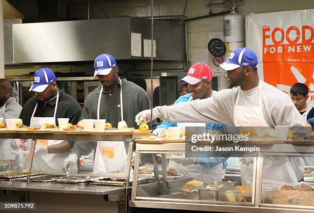 Jeremy Clark, Mathias Kiwanuka, Jerome McDougle, and Justin Tuck of the New York Giants deliver Thanksgiving dinner to the Food Bank Community...
