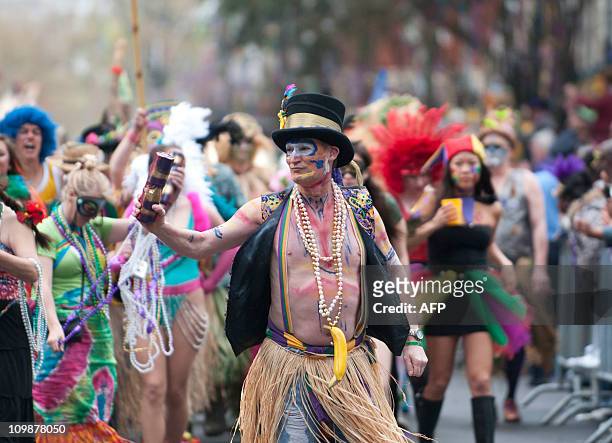 The Mondo Kayo Social and Marching Club make their way along the parade route on St. Charles Avenue during the Mardi Gras parade on Fat Tuesday in...