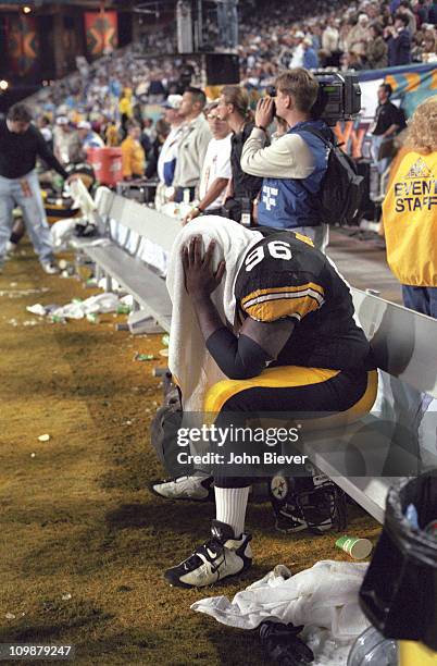 Super Bowl XXX: Pittsburgh Steelers Brentson Buckner looking upset with towel over his head on bench during game vs Dallas Cowboys at Sun Devil...