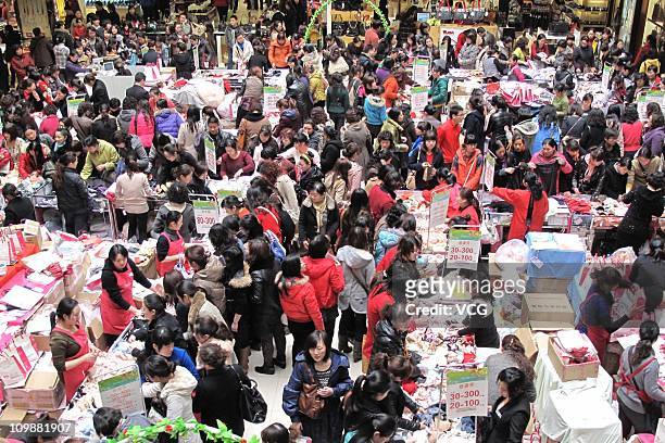 Consumers purchase goods during sales promotion on International Women's Day at a shopping mall on March 8, 2011 in Nanjing, Jiangsu Province of...