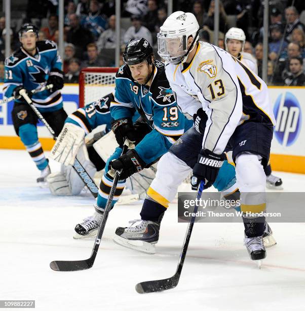 Nick Spaling of the Nashville Predators keeps the puck away from Joe Thornton of the San Jose Sharks in the firs period of an NHL hockey game at the...