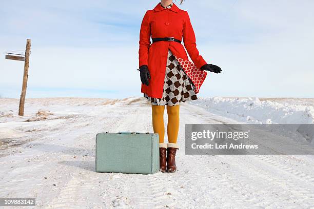 woman with suitcase on snowy road - form fitted stock pictures, royalty-free photos & images
