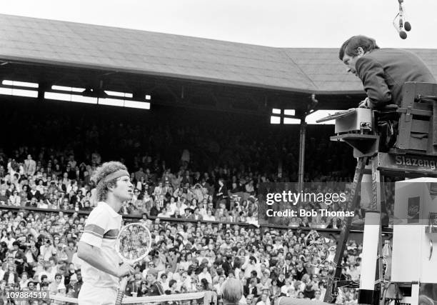 American tennis player John McEnroe argues with the umpire during competition to reach the final and win the Men's Singles tournament to become...