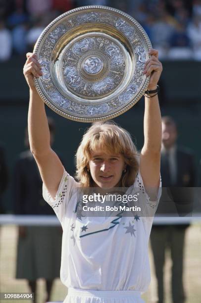 Steffi Graf of Germany holds aloft the Venus Rosewater Dish after defeating Martina Navratilova 57, 62, 61in their Women's Singles Final match at...