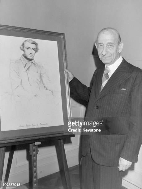 French author Raymond Aron with a portrait of Alexis de Tocqueville, 17th December 1979. He has just been awarded the Tocqueville prize.