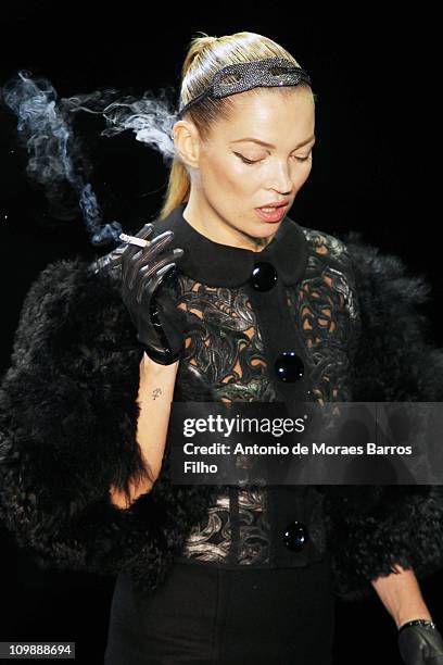 Kate Moss walks the runway during the Louis Vuitton Ready to Wear Autumn/Winter 2011/2012 show during Paris Fashion Week at Cour Carree du Louvre on...