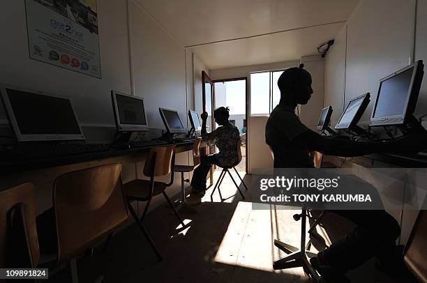 This photo made January 27, 2011 shows residents in the village of Embakasi, some 25 kms from Nairobi, at a solar-powered mobile internet cafe...