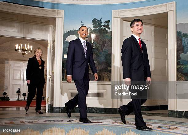 President Barack Obama walks with Secretary of Commerce Gary Locke and U.S. Secretary of State Hillary Clinton before announcing the nomination of...