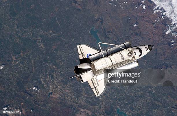 In this handout image provided by NASA, the space shuttle Discovery is seen from the International Space Station as the two orbital spacecraft...