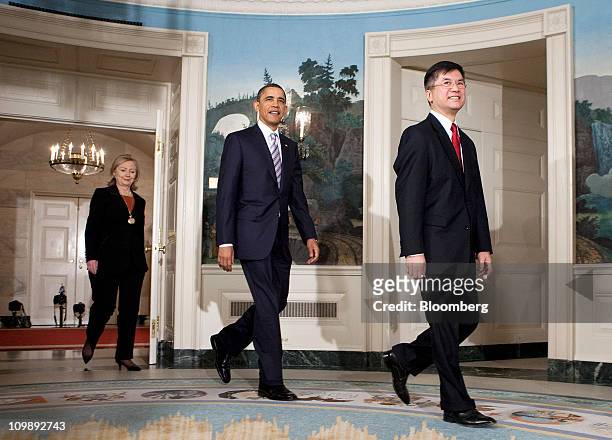 President Barack Obama, center, arrives with Gary Locke, secretary of commerce, right, and Hillary Clinton, secretary of state, to announce the...