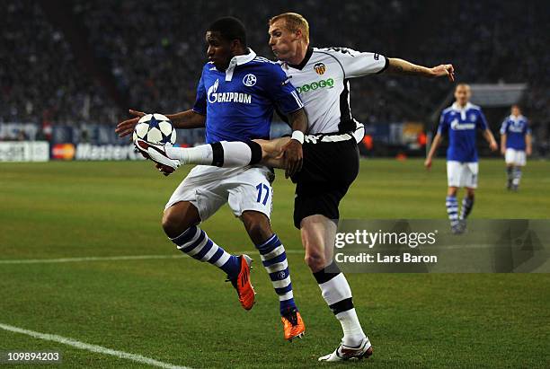 Jefferson Farfan of Schalke is challenged by Jeremy Mathieu of Valencia during the UEFA Champions League round of 16 second leg match between Schalke...