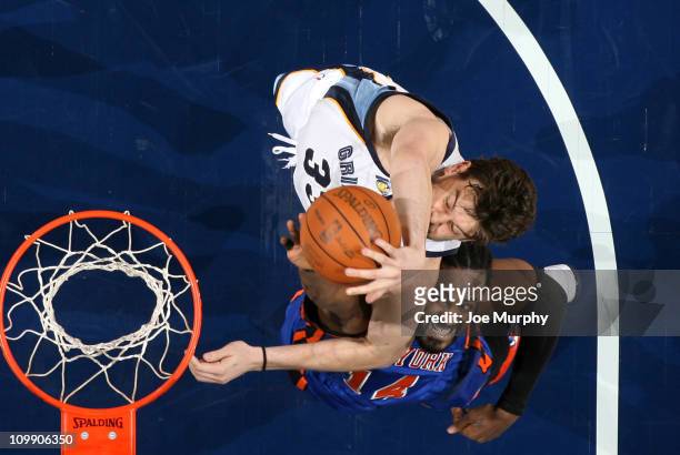 Marc Gasol of the Memphis Grizzlies rebounds against Ronnie Turiaf of the New York Knicks on March 9, 2011 at FedExForum in Memphis, Tennessee. NOTE...