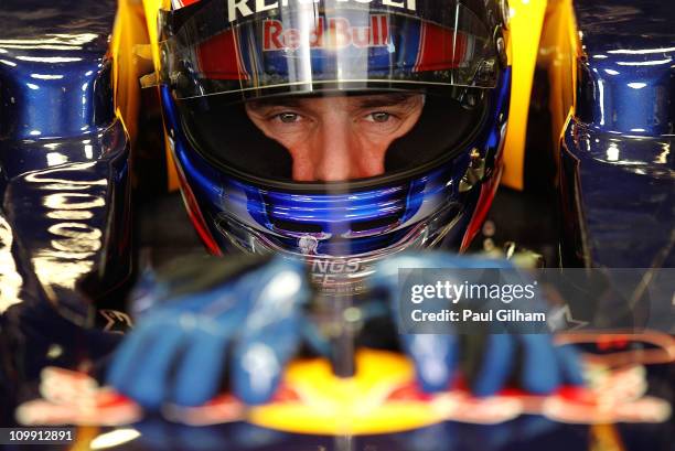 Mark Webber of Australia and Red Bull Racing looks on from his cockpit during day three of the final winter testing at the Circuit de Catalunya on...