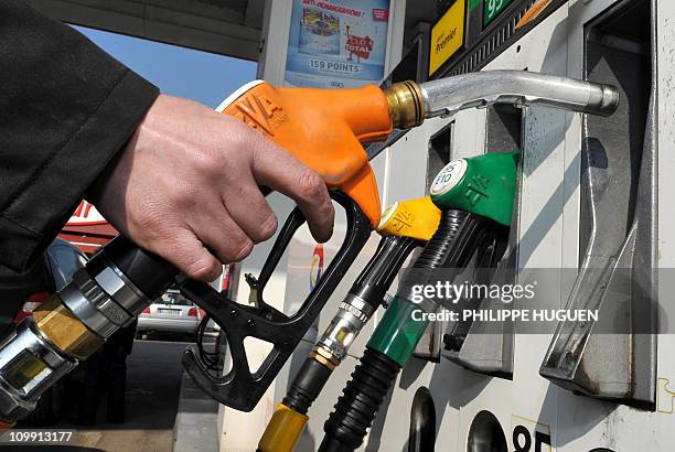 Driver fills up his car at an oil station on March 4, in Lille, northern France. World oil prices advanced today as violence in Libya dominated...