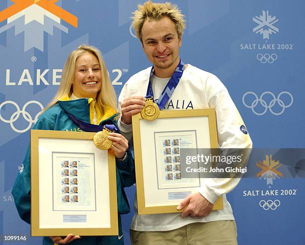 Alisa Camplin and Steven Bradbury, Australia's two gold medalists, pose with their commemorative stamps and gold medals during the Australian press...