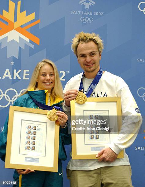 Alisa Camplin and Steven Bradbury, Australia's two gold medalists, pose with their commemorative stamps and gold medals during the Australian press...