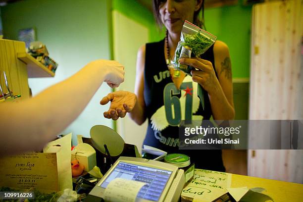 An Israeli woman is buying cannabis at the Tikun Olam company store on March 03, 2011 in Tel Aviv, Israel. In conjunction with Israel's Health...