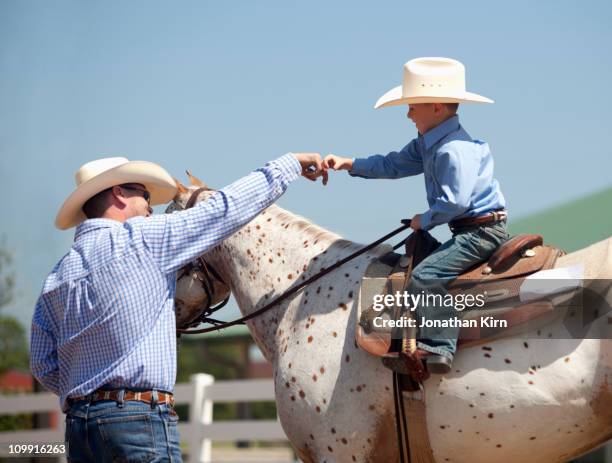 father and son at horse show. - livestock show fotografías e imágenes de stock