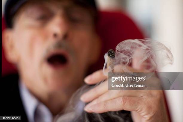 Moshe Rute smokes cannabis at the Hadarim nursing home, on March 09, 2011 in Kibutz Naan, Israel. In conjunction with Israel's Health Ministry, The...