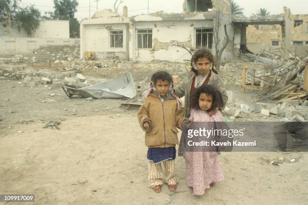 Iraqi kids in the rubble after Allied bombers blasted a neighborhood in the center of Fallujah during the Gulf War, 19th February 1991.
