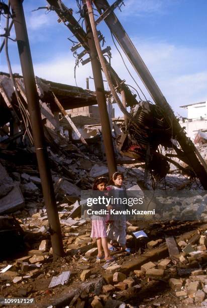 Two young girls play in the rubble of a residential area bombed by Allied forces during the Gulf War, 19th February 1991.