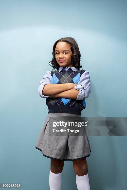 little girl smiling with arms crossed - girl standing crossed arms studio stock pictures, royalty-free photos & images