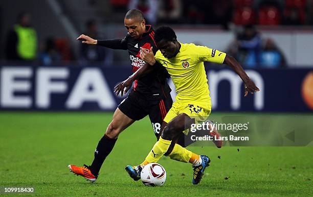 Sidney Sam of Leverkusen challenges Wakaso Mubarak of Villarreal during the UEFA Europa League round of 16 first leg match between Bayer Leverkusen...
