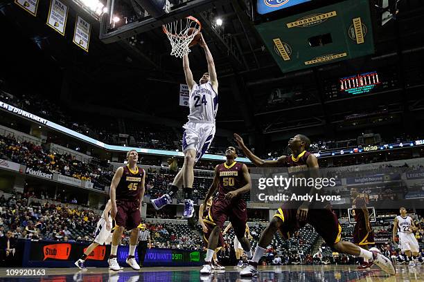 John Shurna of the Northwestern Wildcats dunks against the Minnesota Golden Gophers during the first round of the 2011 Big Ten Men's Basketball...